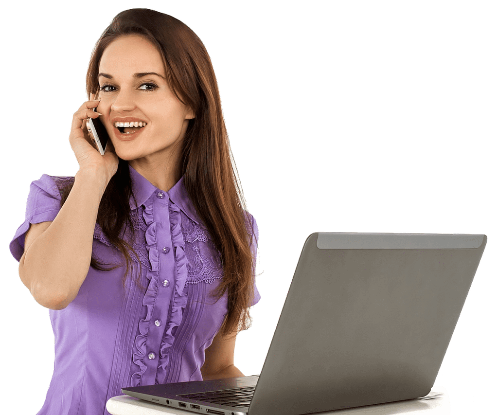 Administrative assistant on the phone in front of a laptop